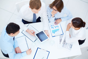 Group of business partners interacting while planning work at meeting
